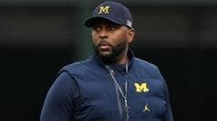 Fired University of Michigan football coach charged with stalking